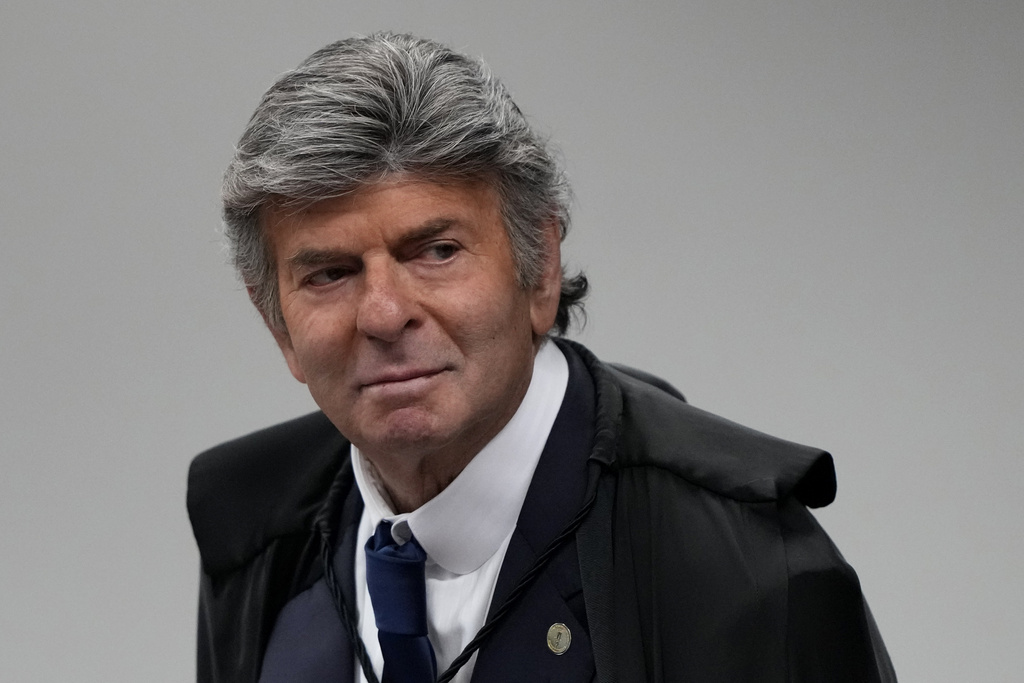 Supreme Court Justice Luiz Fux arrives to attend the verdict and sentencing phase of a trial for those charged in an alleged coup plot to keep former President Jair Bolsonaro in office after his 2022 election defeat, in Brasilia, Brazil, Wednesday, Sept. 10, 2025. (AP Photo/Eraldo Peres)