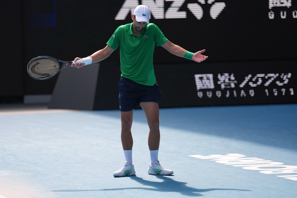 Novak Djokovic of Serbia reacts during his quarterfinal match against Lorenzo Musetti of Italy at the Australian Open tennis championship in Melbourne, Australia, Wednesday, Jan. 28, 2026. (AP Photo/Dita Alangkara)