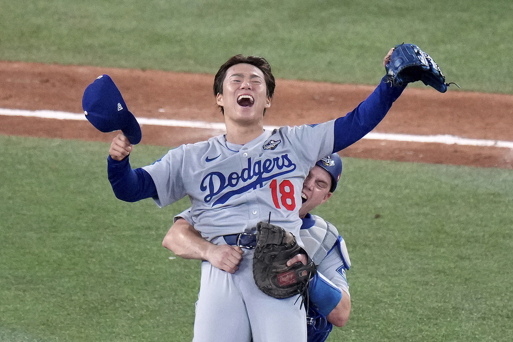 Los Angeles Dodgers' Will Smith, right, celebrates with Yoshinobu Yamamoto (18) after the team defeated the Toronto Blue Jays in Game 7 of baseball's World Series, Sunday, Nov. 2, 2025, in Toronto. (Chris Young/The Canadian Press via AP)