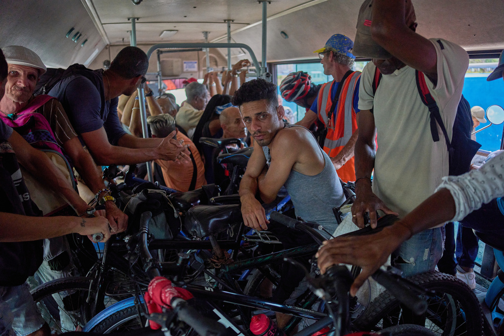 People with their bicycles and motorcycles cross the Bay Tunnel in a public bus in Havana, Wednesday, April 8, 2026. (AP Photo/Ramon Espinosa)