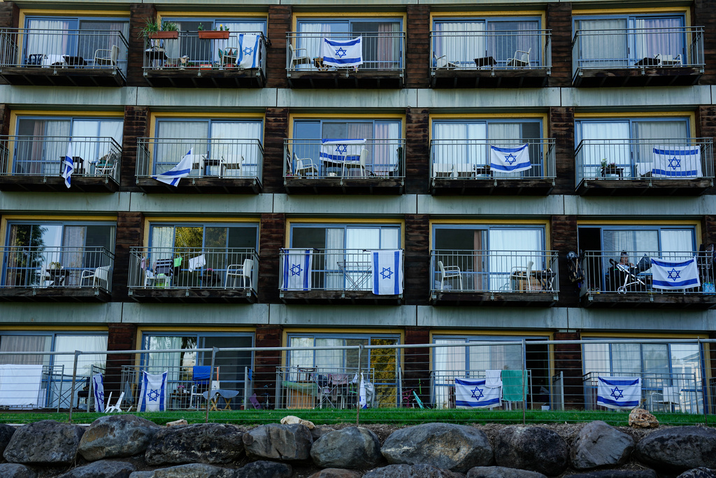 FILE - Israeli flags decorate rooms of Israelis who evacuated from cities and towns along the border with Lebanon, in kibbutz Ginosar hotel, northern Israel, Tuesday, March 5, 2024. (AP Photo/Ariel Schalit, file)