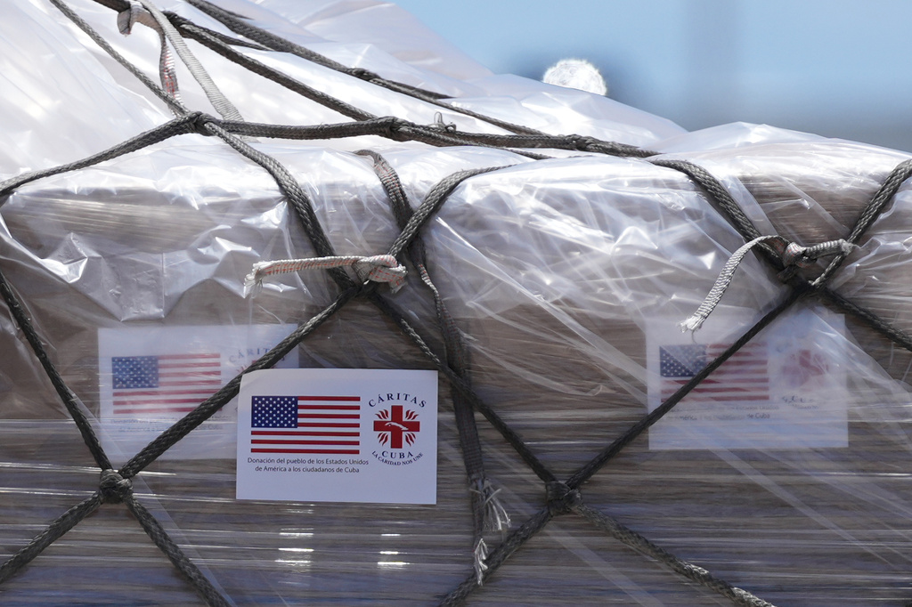 People load pallets containing food and hygiene kits for a humanitarian assistance flight to Cuba organized by the Trump administration as the U.S. continues to put pressure on the island's government, Tuesday, July 21, 2026, in Miami. (AP Photo/Lynne Sladky)