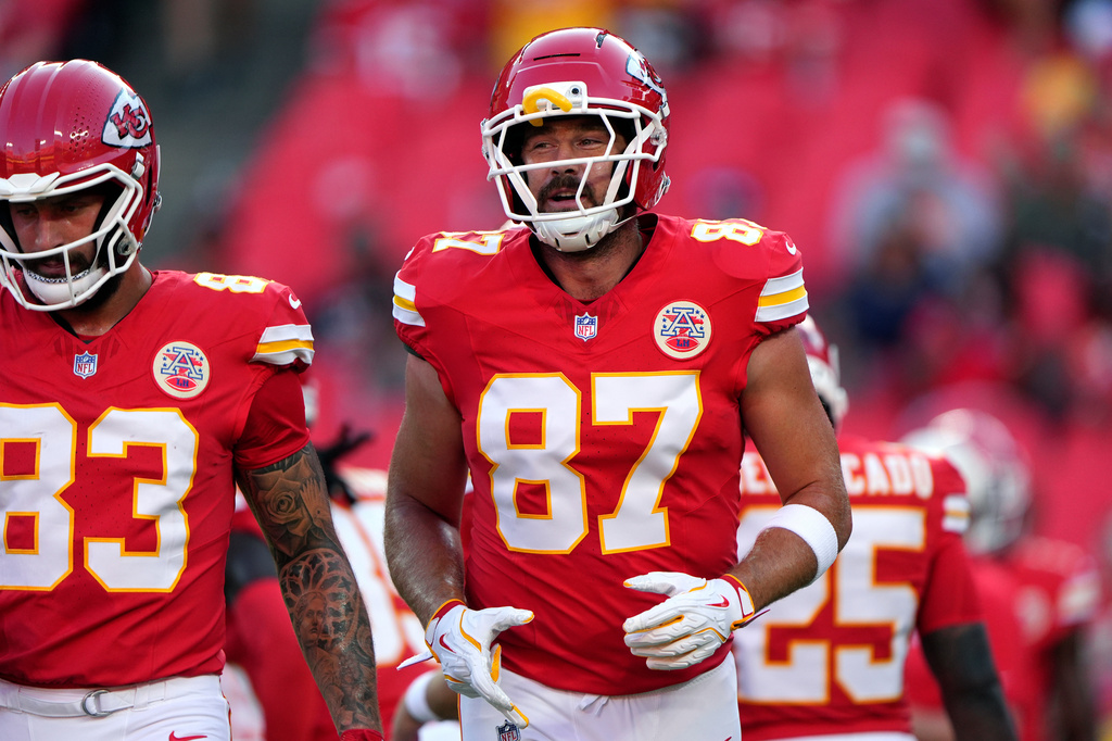 Kansas City Chiefs tight ends Travis Kelce (87) and Noah Gray (83) warm up prior to a preseason NFL football game against the Seattle Seahawks, Friday, Aug. 28, 2026, in Kansas City, Mo. (AP Photo/Charlie Riedel)