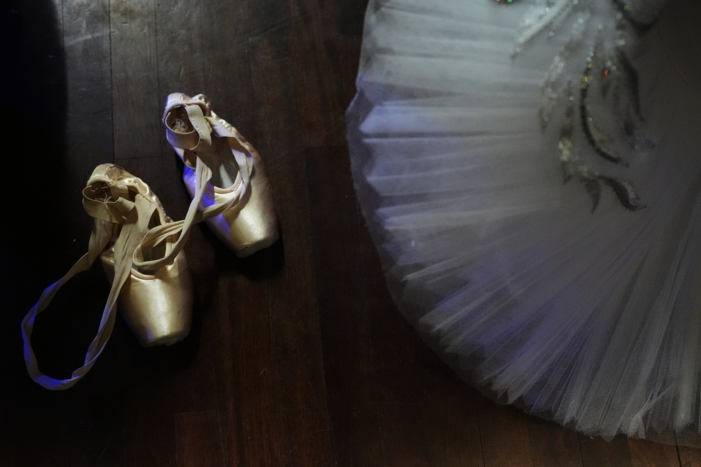 Daniela Quiroga, right, sits on a back stage floor next to her pointe shoes while waiting her turn for Senior Classical Competition Women Ages 16-17 during the Youth America Grand Prix (YAGP) Semi-Finals at Dominican University Performing Arts Center in River Forest, Ill., Saturday, Feb. 7, 2026. (AP Photo/Nam Y. Huh)