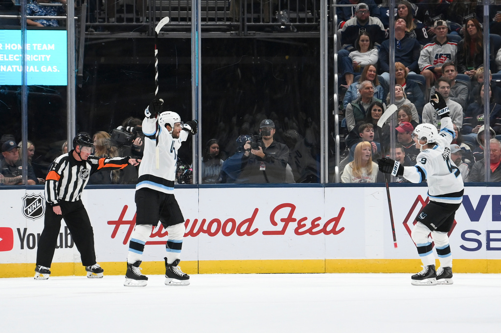 Utah Mammoth's Nick Schmaltz, second from left, celebrates with Clayton Keller, right, after scoring against the Columbus Blue Jackets during the first period of an NHL hockey game, Saturday, Oct. 3, 2026, in Columbus, Ohio. (AP Photo/Tanner Pearson)
