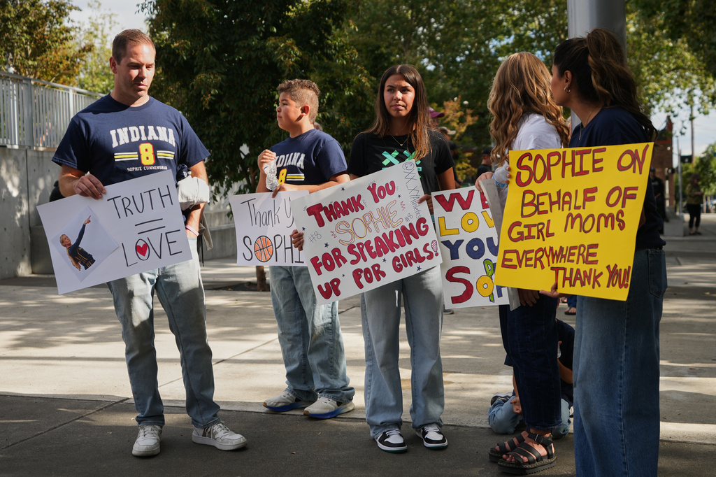 People gather in support of Indiana Fever guard Sophie Cunningham following her comments on transgender athletes before a WNBA basketball game between the Seattle Storm and the Indiana Fever, Tuesday, July 28, 2026, in Seattle. (AP Photo/Lindsey Wasson)