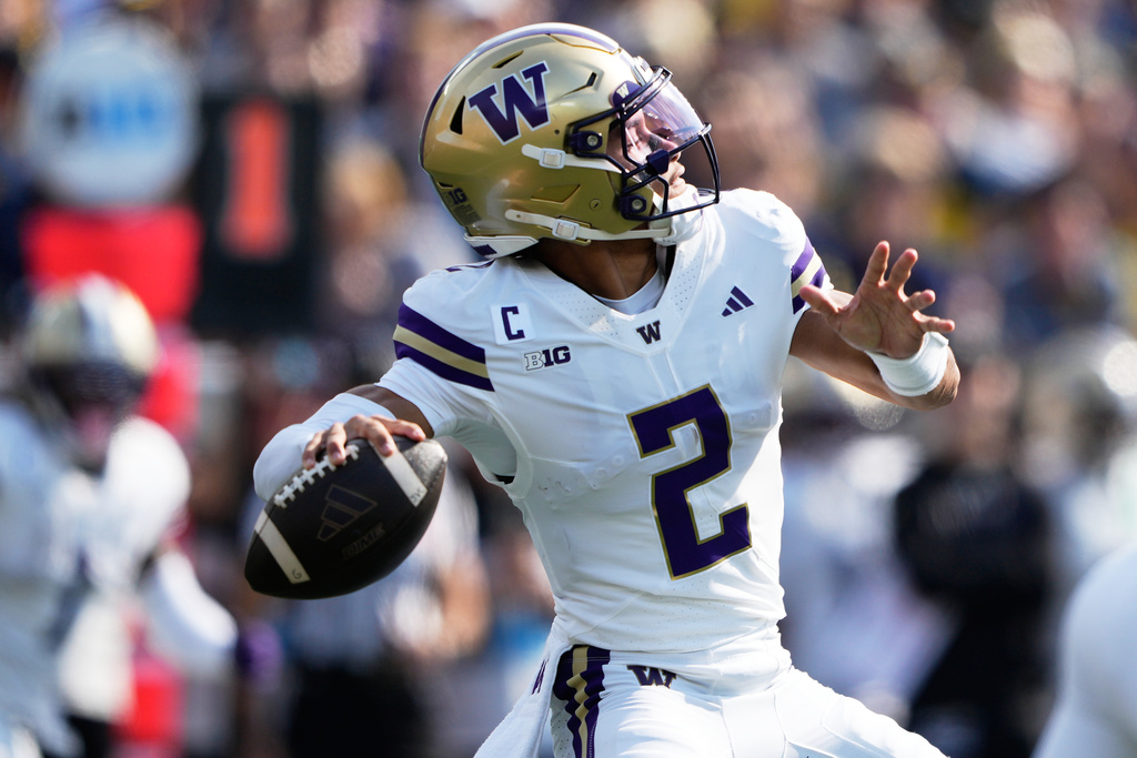 Washington quarterback Demond Williams Jr. throws during the first half of an NCAA college football game against Michigan, Saturday, Oct. 18, 2025, in Ann Arbor, Mich. (AP Photo/Ryan Sun)