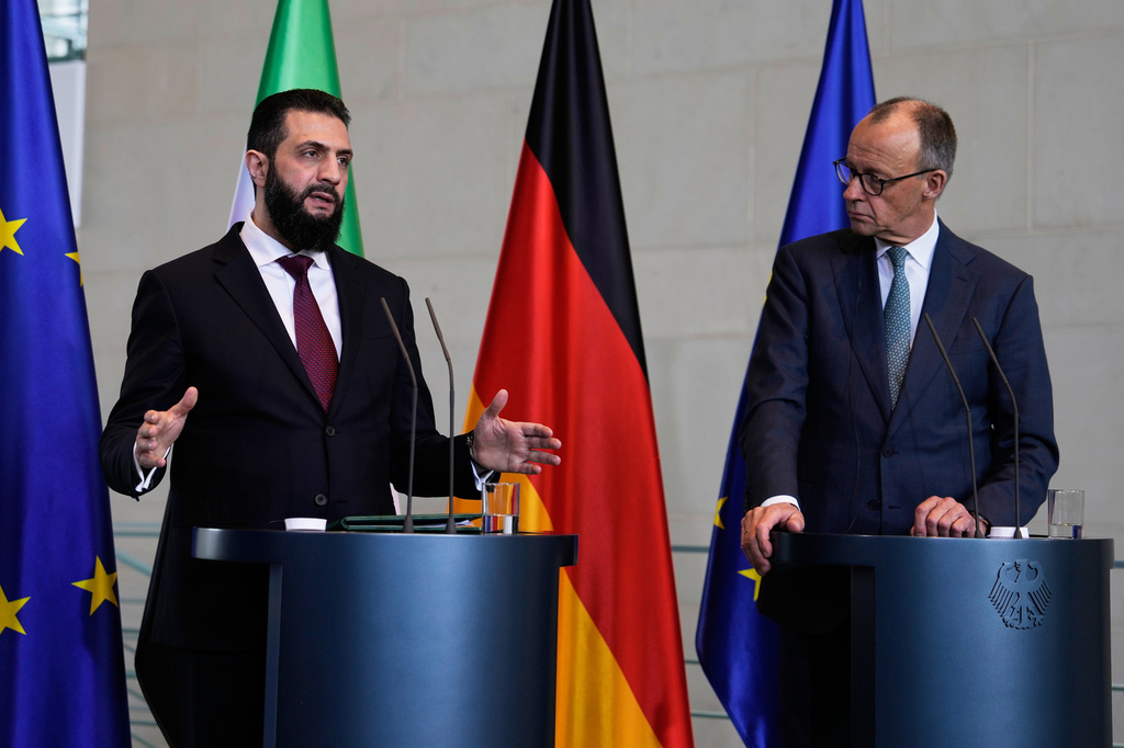 German Chancellor Friedrich Merz, right, and Syrian President Ahmad al-Sharaa attend a press conference in Berlin, Germany, Monday, March 30, 2026. (AP Photo/Markus Schreiber)