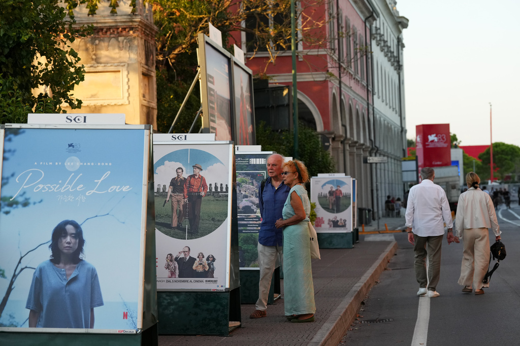 People view film posters prior to the 83rd edition of the Venice Film Festival in Venice, Italy, on Monday, Aug. 31, 2026. (Photo by Alessandra Tarantino/Invision/AP)