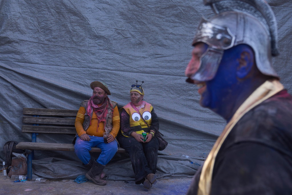 Revelers take part in the annual flour war marking the end of the Carnival season on Clean Monday in Galaxidi, about 200 kilometers (120 miles) west of Athens, Feb. 23, 2026, starting the 40-day Christian Lent fast leading to Easter. (AP Photo/Petros Giannakouris)