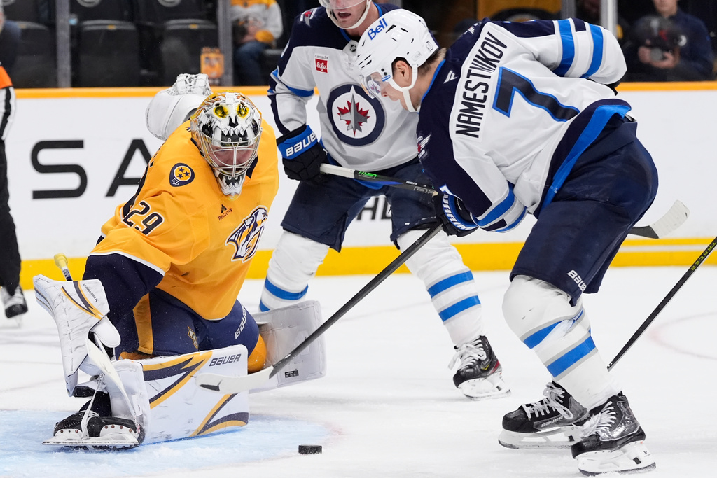 Nashville Predators goaltender Justus Annunen (29) blocks a shot on goal by Winnipeg Jets center Vladislav Namestnikov (7) during the third period of an NHL hockey game Saturday, Nov. 29, 2025, in Nashville, Tenn. (AP Photo/George Walker IV)