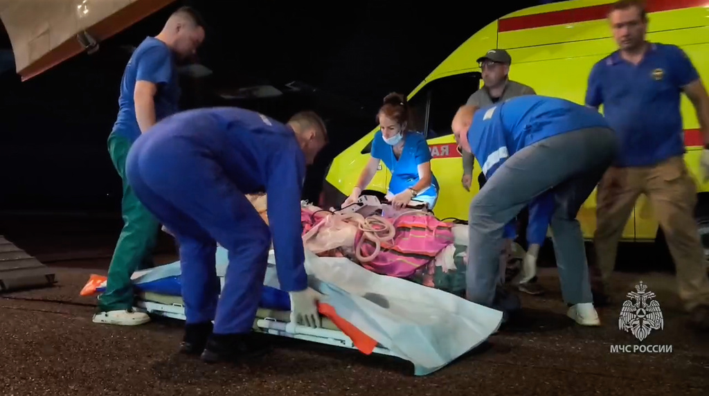 In this image made from video provided by Russian Emergency Situations Ministry press service, medical and rescue workers put those injured in a fire at the Amur Gas Chemical Complex on a plane to Moscow in Blagoveschensk, Amur region, Russia, Thursday, Aug. 27, 2026. (Ministry of Emergency Situations press service via AP)