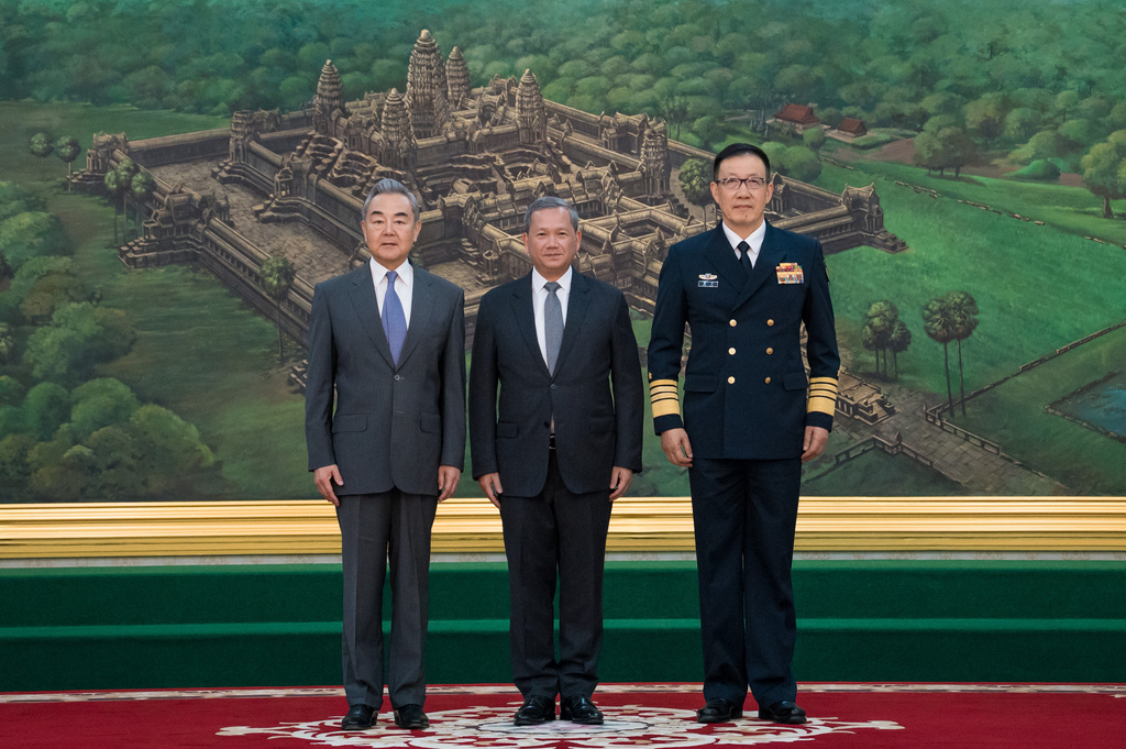 In this photo released by Agence Kampuchea Press (AKP), Chinese Foreign Minister Wang Yi, left, Cambodian Prime Minister Hun Manet, center, and Chinese Defense Minister Dong Jun pose prior to a meeting at Peace Palace in Phnom Penh, Cambodia, Wednesday, April 22, 2026. (Agence Kampuchea Press via AP)