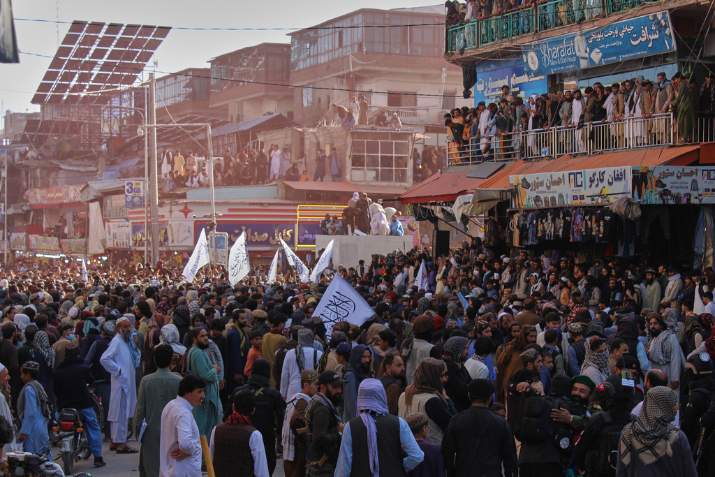 Afghan protesters hold Taliban flags during a demonstration condemning Pakistan's airstrikes in Afghanistan, in Khost province, Monday, Oct. 13, 2025. (AP Photo/Saifullah Zahir)