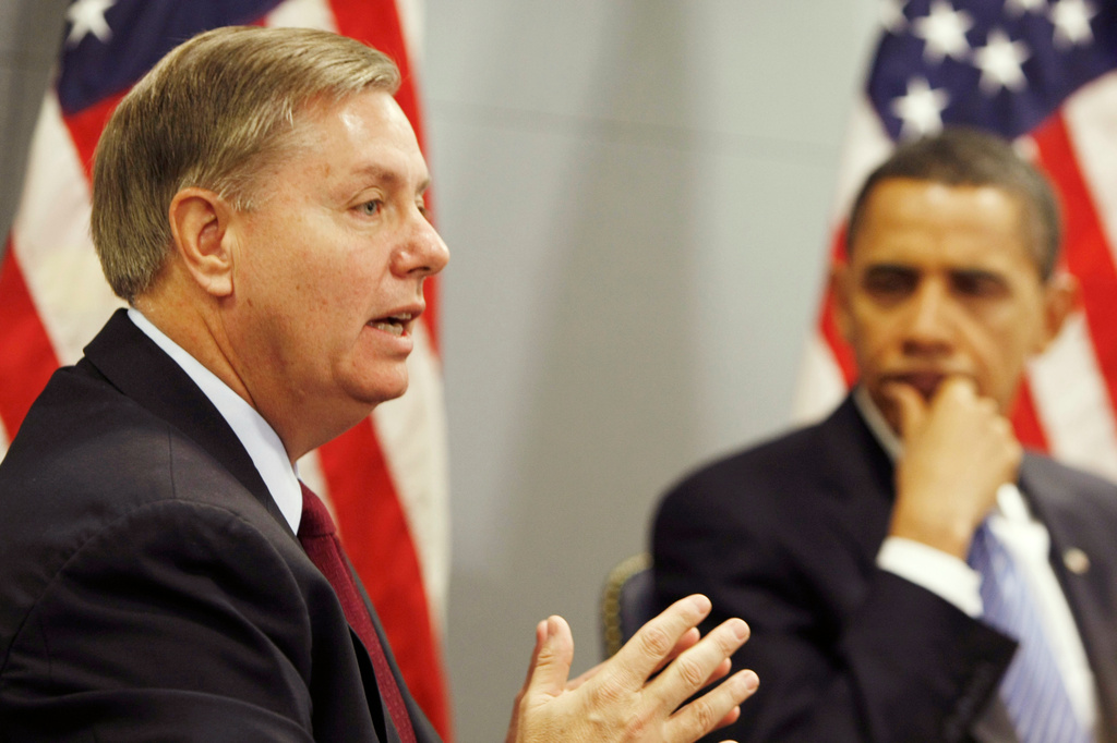 FILE - President-elect Barack Obama looks on as Sen. Lindsey Graham, R-S.C. discusses his recent trip to Afghanistan, Iraq, Kuwait and Pakistan, Jan. 14, 2009, at Obama's transition office in Washington. (AP Photo/Gerald Herbert, File)
