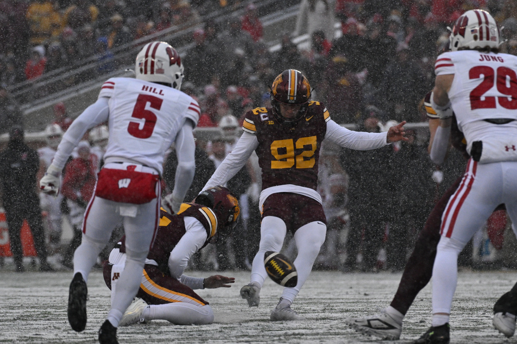 FILE - Minnesota kicker Brady Denaburg attempts a field goal during the first half of an NCAA college football game against Wisconsin Nov. 29, 2025, in Minneapolis. (AP Photo/Tom Baker, File)