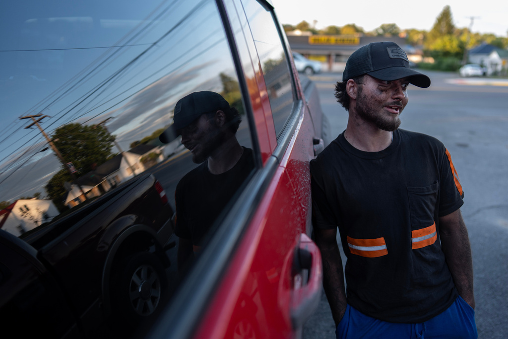 Coal miner Ethan Carper leans against his truck outside a convenience store, Wednesday, Sept. 17, 2025, in Oak Hill, W.Va. (AP Photo/Carolyn Kaster)