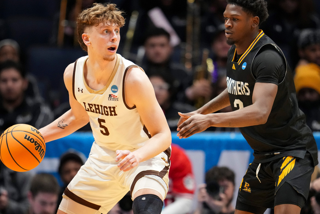 Lehigh forward Edouard Benoit (5) controls the ball against Prairie View A&M guard Dontae Horne during the first half of a First Four college basketball game in the NCAA Tournament in Dayton, Ohio, Wednesday, March 18, 2026. (AP Photo/Jeff Dean)
