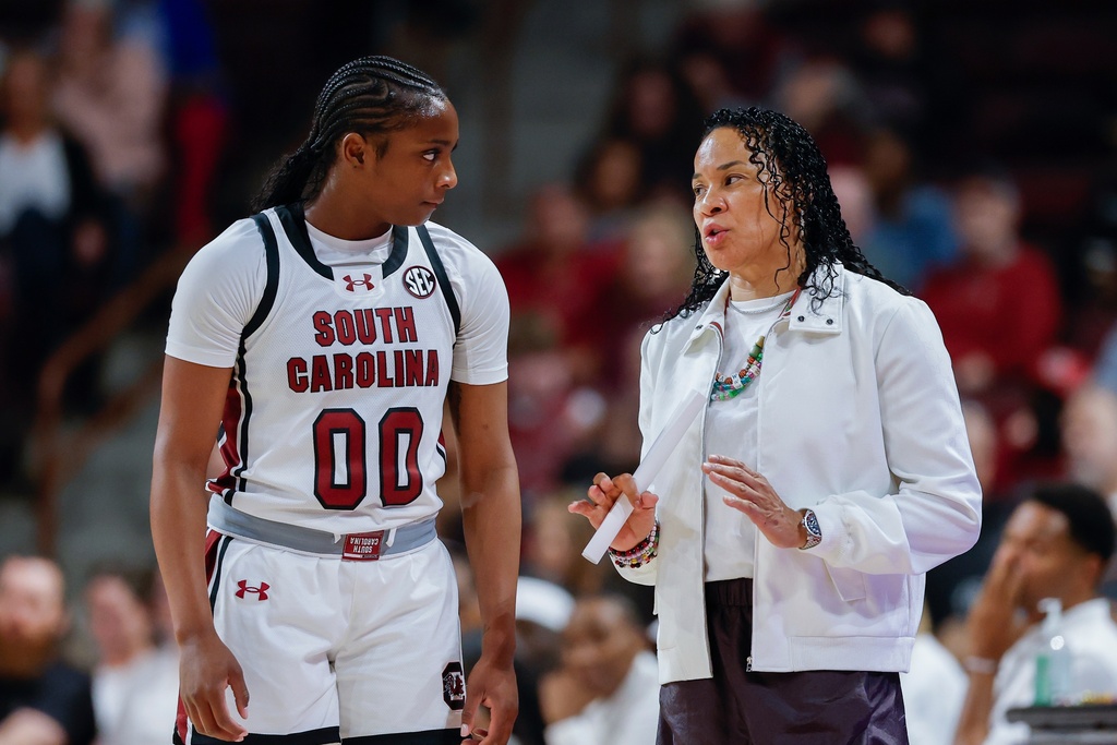 South Carolina guard Ta'Niya Latson (00) listens to head coach Dawn Staley during the first half of an NCAA college basketball game against Winthrop in Columbia, S.C., Wednesday, Nov. 19, 2025. (AP Photo/Nell Redmond)