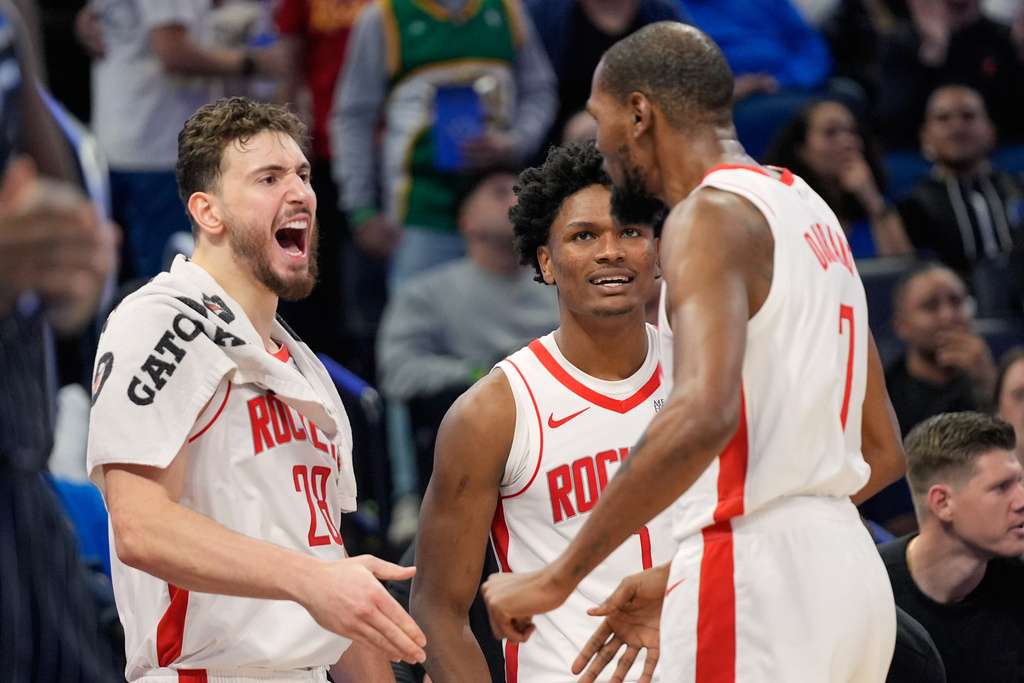 Houston Rockets forward Kevin Durant (7) celebrates with teammates center Alperen Sengun (28) and guard Amen Thompson, center, after making a shot after he was fouled during the second half of an NBA basketball game against the Orlando Magic, Thursday, Feb. 26, 2026, in Orlando, Fla. (AP Photo/John Raoux)