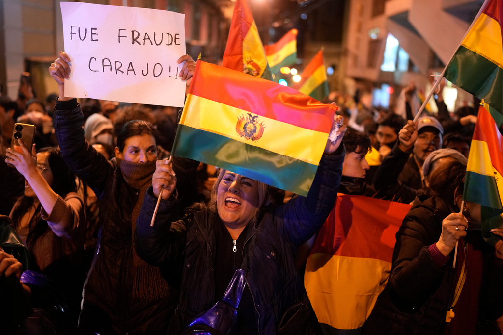 Protesters shout, "It was fraud!" about the results of the day prior's presidential runoff election in La Paz, Bolivia, Monday, Oct. 20, 2025. (AP Photo/Juan Karita)