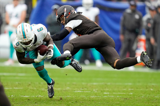 Miami Dolphins wide receiver Malik Washington (6) is hit by Cleveland Browns safety Rayshawn Jenkins in the second half of an NFL football game in Cleveland, Sunday, Oct. 19, 2025. (AP Photo/Sue Ogrocki) Miami Dolphins wide receiver Malik Washington (6) is hit by Cleveland Browns safety Rayshawn Jenkins in the second half of an NFL football game in Cleveland, Sunday, Oct. 19, 2025. (AP Photo/Sue Ogrocki)