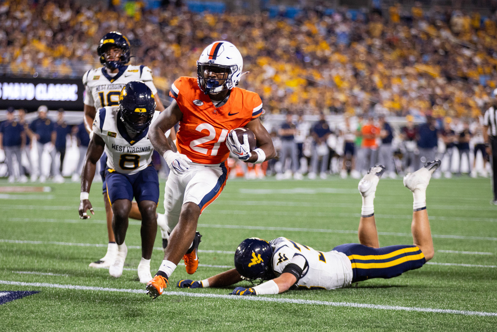 Virginia running back Jekail Middlebrook (21) runs in for a touchdown against West Virginia in the first half in an NCAA college football game Saturday, Sept. 19, 2026, in Charlotte, N.C. (AP Photo/Scott Kinser)
