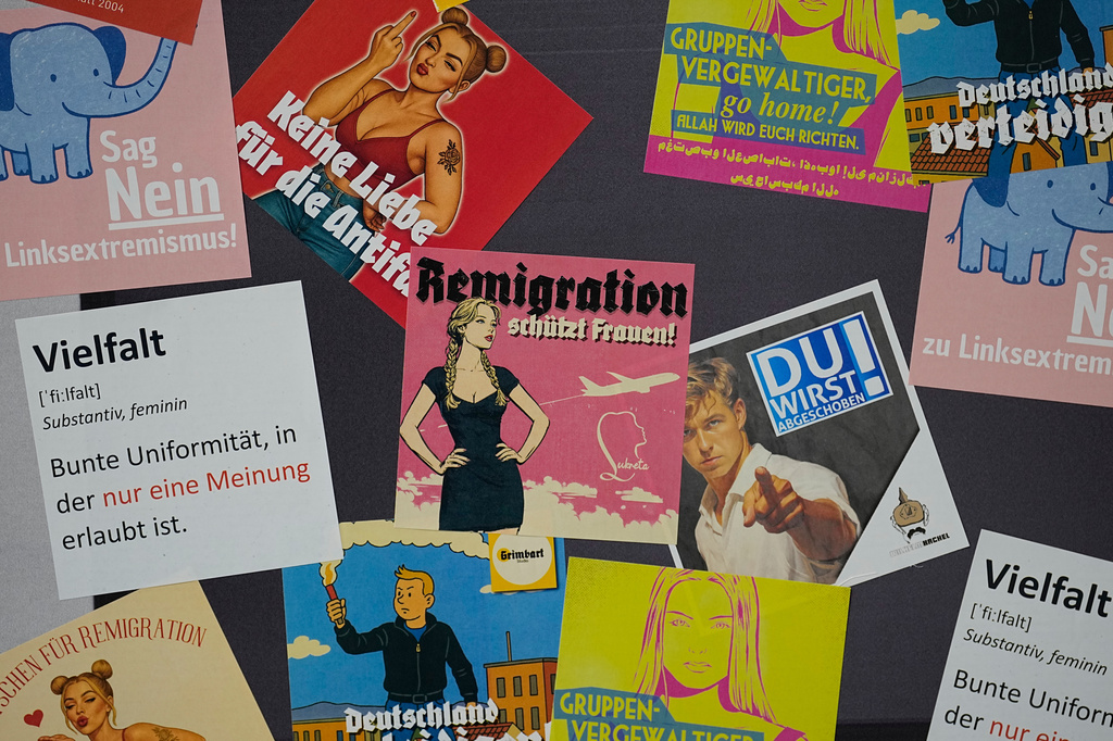 FILE - Stickers are offered at the re-founding of the AfD youth organization in Giessen, Germany, Nov. 29, 2025. (AP Photo/Martin Meissner, File)