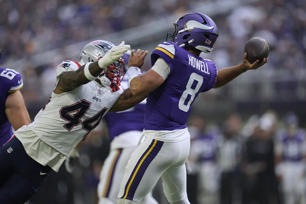 Minnesota Vikings quarterback Sam Howell (8) passes under pressure from New England Patriots linebacker K'Lavon Chaisson (44) during the first half of a preseason NFL football game Saturday, Aug. 16, 2025, in Minneapolis. (AP Photo/Abbie Parr)