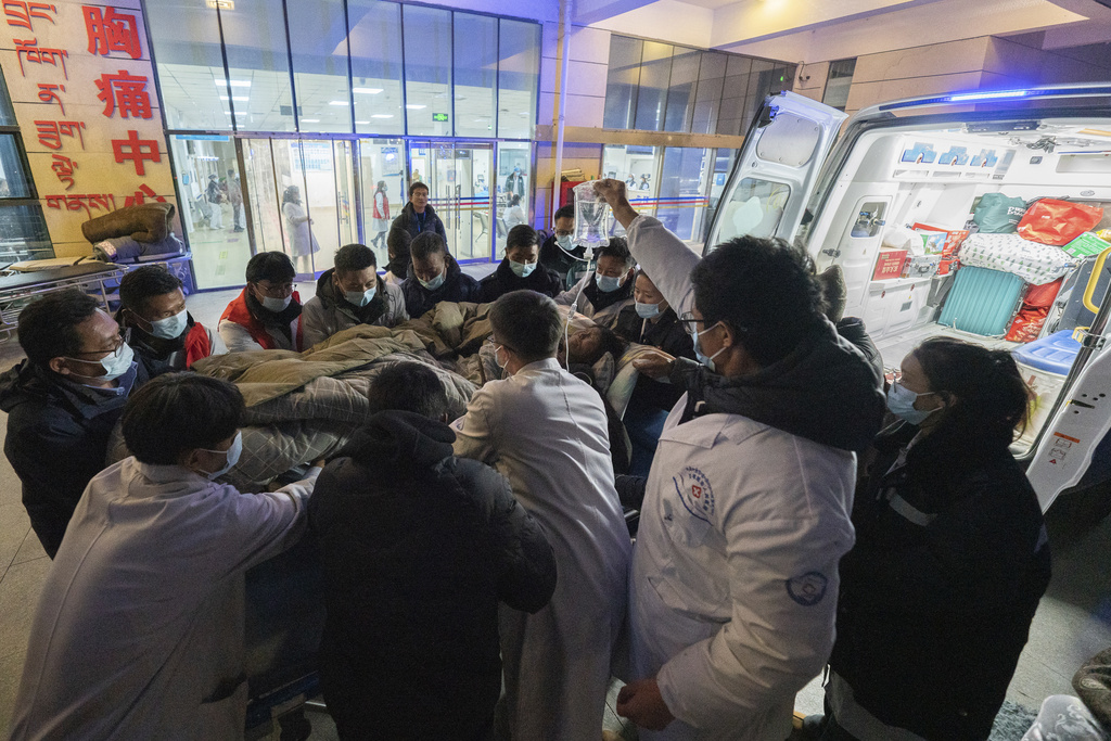 In this photo released by Xinhua News Agency, medical workers transfer an injured resident to the emergency room in the aftermath of an earthquake at the Xigaze People's Hospital in Xigaze City, southwest China's Tibet Autonomous Region, Wednesday Jan. 8, 2025. (Tenzin Nyida/Xinhua via AP)