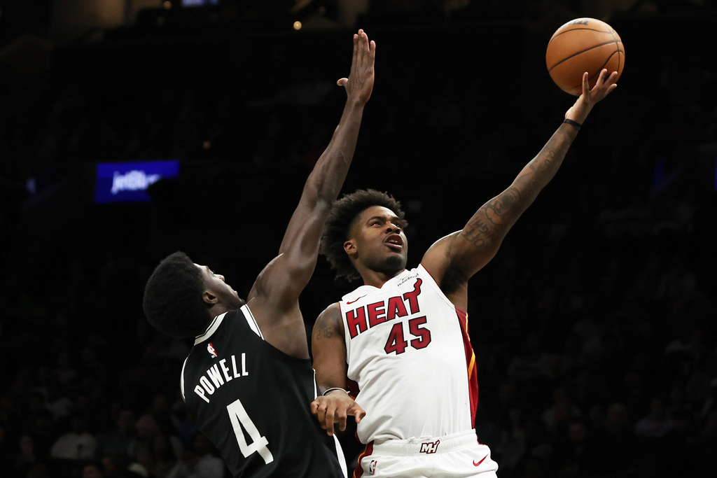 Miami Heat guard Davion Mitchell (45) goes up for a shot past Brooklyn Nets guard Drake Powell (4) during the first half of an NBA basketball game, Thursday, Dec. 18, 2025, in New York. (AP Photo/Heather Khalifa)