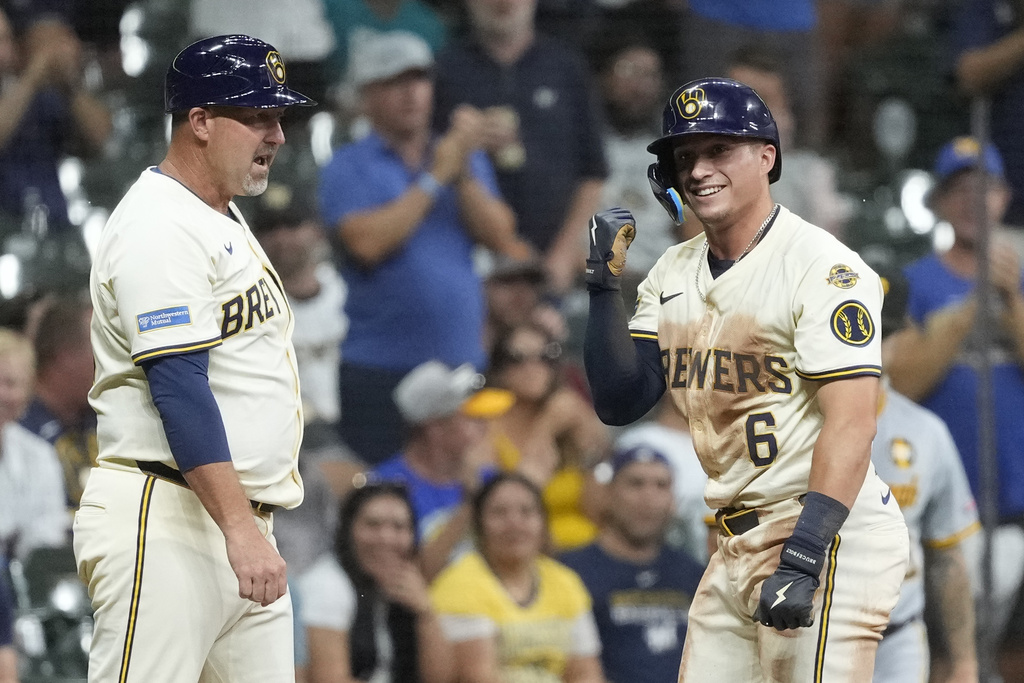 Milwaukee Brewers' Isaac Collins (6) gestures after hitting a triple during the sixth inning of a baseball game against the Pittsburgh Pirates, Monday, Aug. 11, 2025, in Milwaukee. (AP Photo/Aaron Gash)