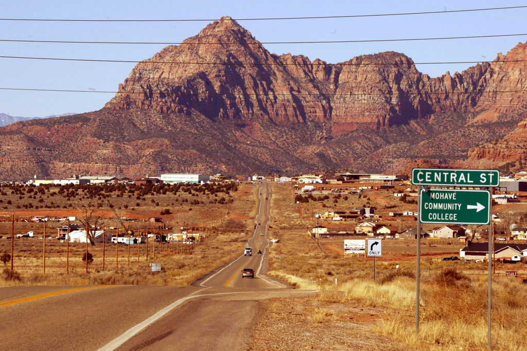 FILE - The twin towns of Colorado City, Ariz., and Hildale, Utah, are surrounded by a backdrop of the Vermillion Cliffs, Thursday, Jan. 15, 2004. The polygamist town was originally known as Short Creek, but residents later changed the name after an infamous 1953 raid by Arizona officials who hauled polygamist men away and sent more than 200 children to foster homes. (AP Photo/Joe Cavaretta, File)