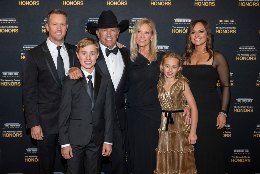 2025 Kennedy Center Honoree George Strait, center left, and his family arrive on the red carpet for the 48th Kennedy Center Honors Medallion Reception, hosted at the U.S. Department of State, Saturday, Dec. 6, 2025 in Washington. (AP Photo/Kevin Wolf)