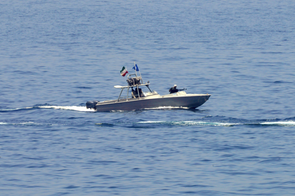 FILE - An Iranian Revolutionary Guard vessel watches an American warship in the Strait of Hormuz, May 19, 2023. (AP Photo/Jon Gambrell, File)