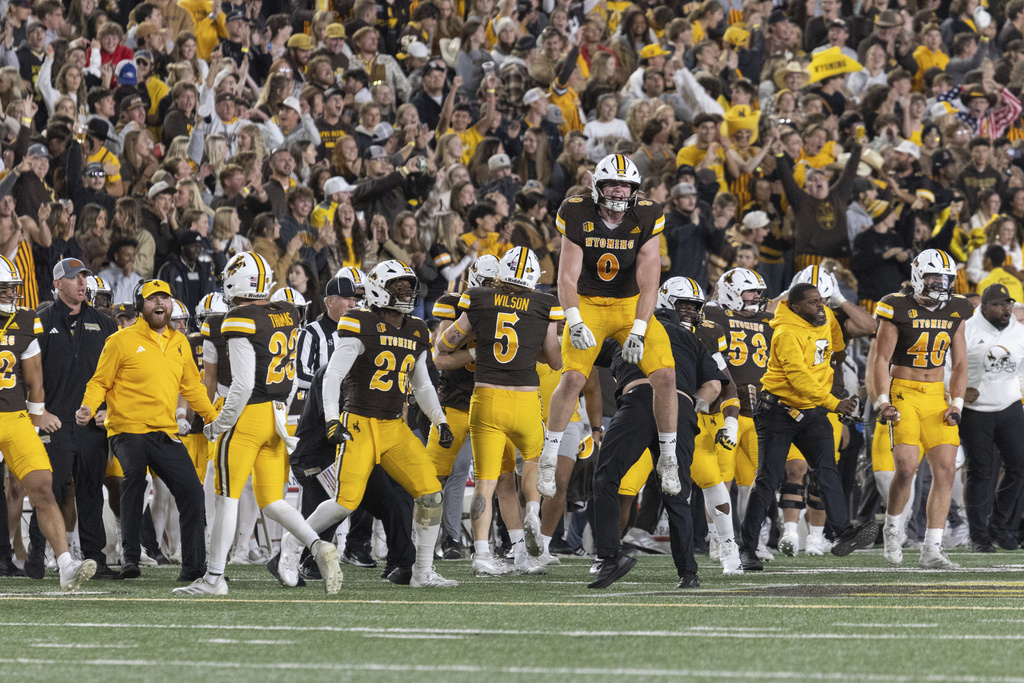 Wyoming cowboys celebrate at haftime after blocking a field goal attemp during the first half of an NCAA college football game, Saturday, Sept. 13, 2025, in Laramie, Wyo. (AP Photo/Matthew Idler)