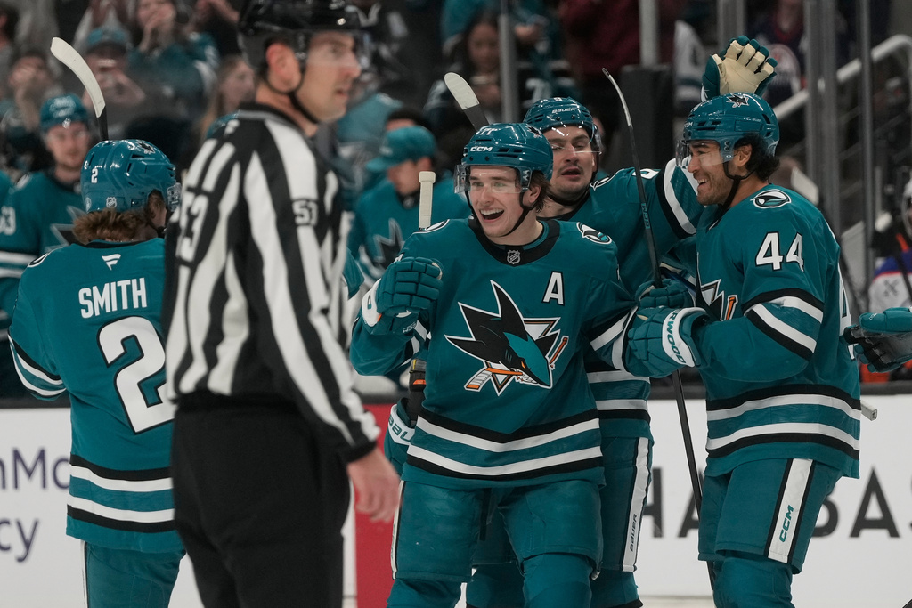 San Jose Sharks center Macklin Celebrini, middle, is congratulated by teammates after scoring against the Edmonton Oilers during the first period of an NHL hockey game in San Jose, Calif., Saturday, Feb. 28, 2026. (AP Photo/Jeff Chiu)
