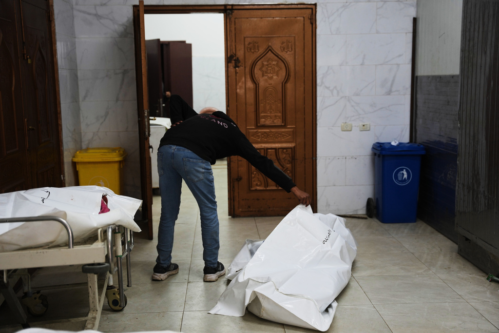 The bodies of Palestinians killed in an Israeli army strike are brought to the morgue at Nasser Hospital in Khan Younis, in the Gaza Strip, Thursday, Jan. 8, 2026. (AP Photo/Abdel Kareem Hana)