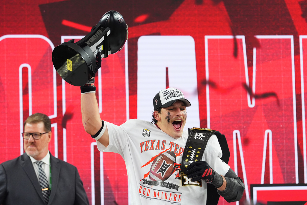 Texas Tech linebacker Ben Roberts celebrates after being awared the Most Outstanding Player trophy following the team's win in the Big 12 Conference championship NCAA college football game against BYU Saturday, Dec. 6, 2025, in Arlington, Texas. (AP Photo/Julio Cortez)