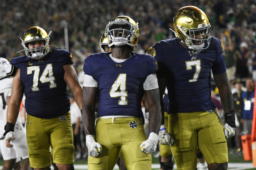 Notre Dame running back Jeremiyah Love (4) celebrates with teammates after rushing for a touchdown during the fourth quarter of an NCAA football game against Texas A&M Saturday, Sept. 13, 2025, in South Bend, Ind. (AP Photo/Paul Beaty)