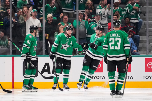 Dallas Stars' Tyler Seguin (91), Miro Heiskanen, second from left, Mikko Rantanen, second from right, and Esa Lindell (23) celebrate a goal scored by Heiskanen in the second period of an NHL hockey game against the Carolina Hurricanes Saturday, Oct. 25, 2025, in Dallas. (AP Photo/Tony Gutierrez) Dallas Stars' Tyler Seguin (91), Miro Heiskanen, second from left, Mikko Rantanen, second from right, and Esa Lindell (23) celebrate a goal scored by Heiskanen in the second period of an NHL hockey game against the Carolina Hurricanes Saturday, Oct. 25, 2025, in Dallas. (AP Photo/Tony Gutierrez)