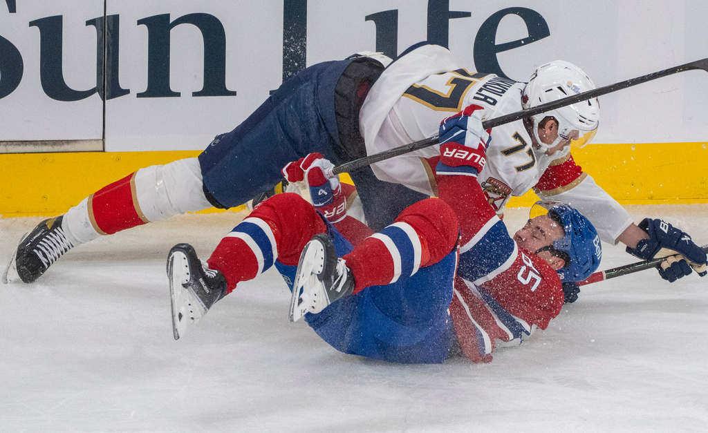 Montreal Canadiens' Alexandre Texier (85) is tripped up by Florida Panthers' Niko Mikkola (77) during the first period of an NHL hockey game in Montreal, Thursday, Jan. 8, 2026. (Christinne Muschi/The Canadian Press via AP)