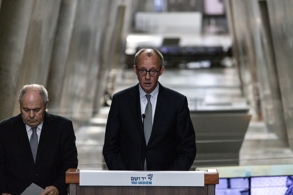 German Chancellor Friedrich Merz, right, makes a statement next to Dani Dayan, chairman of the Yad Vashem Holocaust Memorial Museum in Jerusalem, Sunday, Dec. 7, 2025. (John Wessels, Pool Photo via AP)