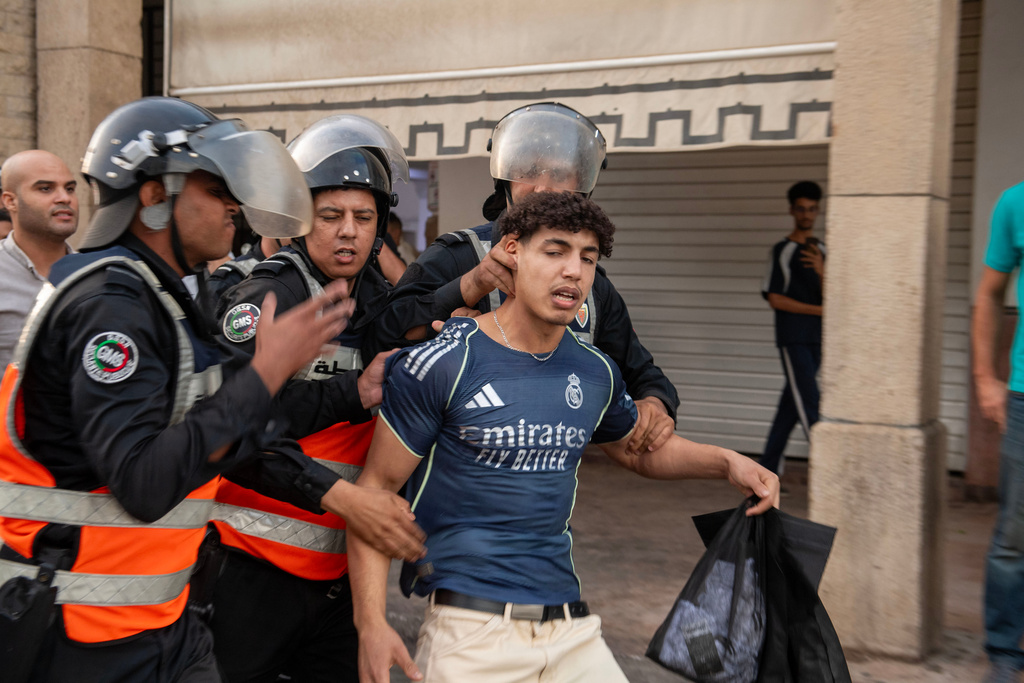 Security forces disperse and arrest protesters during a demonstration demanding healthcare and education reforms, in Rabat, Sunday, Sept. 28, 2025. (AP Photo)