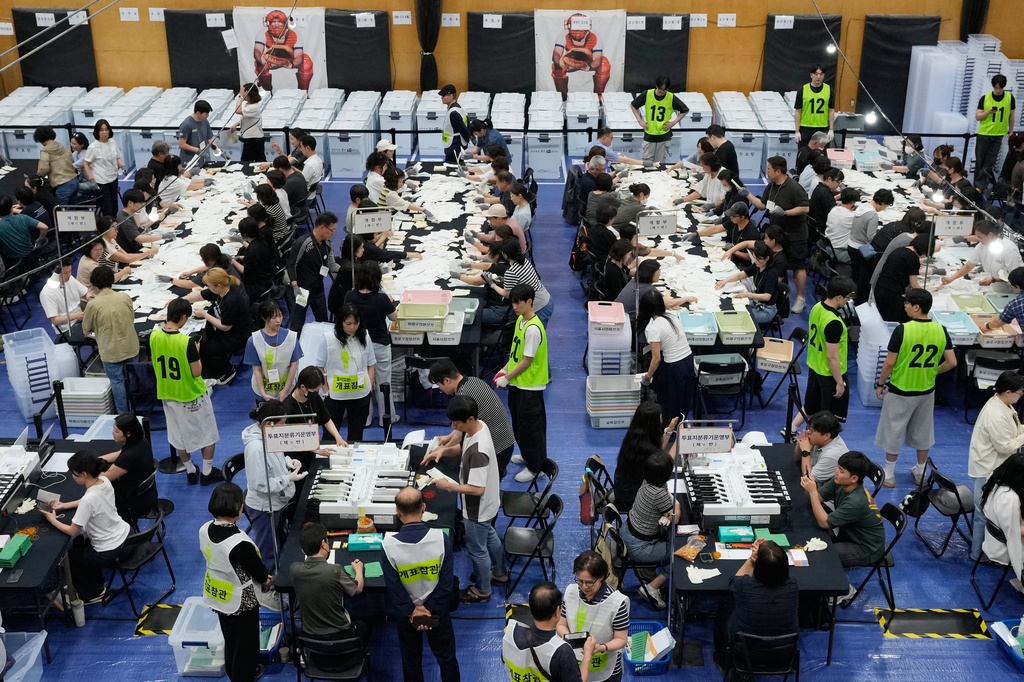 Election Commission officials sort out ballots for counting at the local elections at a gymnasium in Seoul, South Korea, Wednesday, June 3, 2026. (AP Photo/Ahn Young-joon)