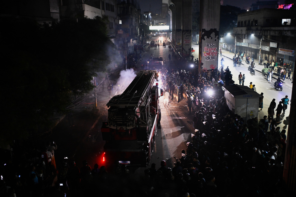 A fire engine arrives at the premises of The Daily Star newspaper after angry protesters set it on fire after news reached the country from Singapore of the death of a prominent activist Sharif Osman Hadi, in Dhaka, Bangladesh, Friday, Dec. 19, 2025. (AP Photo/Mahmud Hossain Opu)