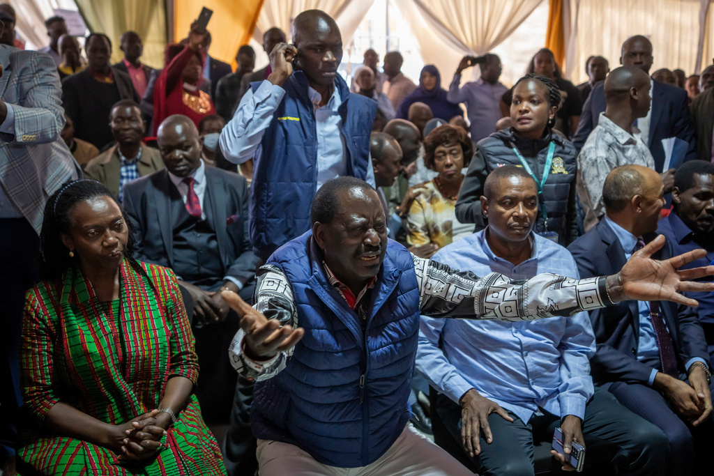 Presidential candidate Raila Odinga, center, accompanied by running mate Martha Karua, left, gestures to the media as he prepares to hand over the petition to the Supreme Court challenging the election results, in Nairobi, Kenya Monday, Aug. 22, 2022. (AP Photo/Ben Curtis)