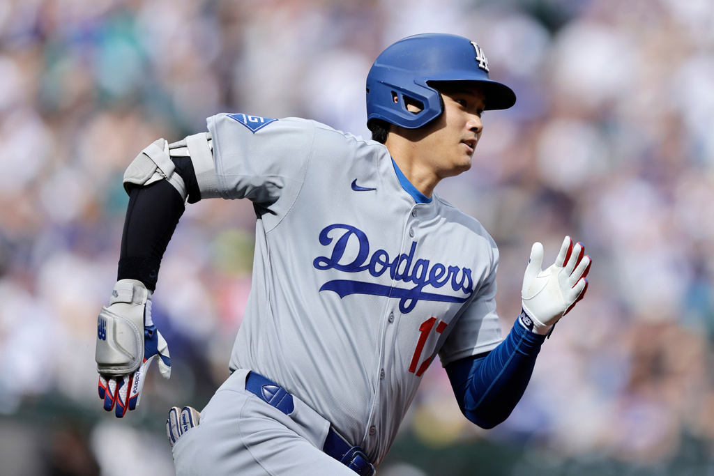 Los Angeles Dodgers Shohei Ohtani runs toward first base as he doubles against the Seattle Mariners during a baseball game, Sunday, Sept. 28, 2025, in Seattle. (AP Photo/John Froschauer)