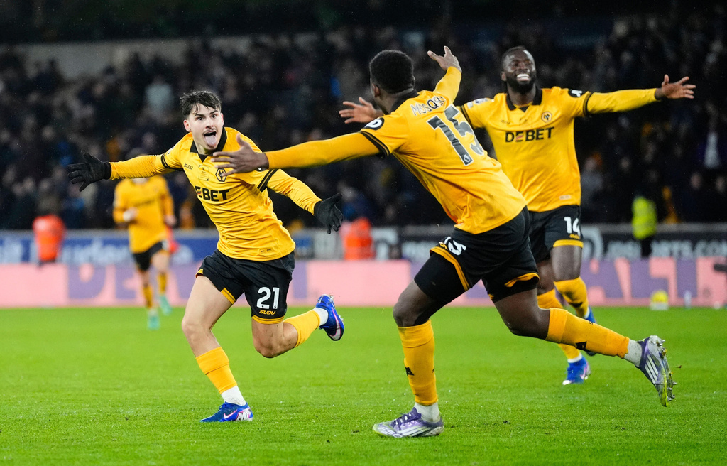 Wolverhampton Wanderers' Rodrigo Gomes, left, celebrates scoring their second goal during their English Premier League soccer match against Aston Villa in Wolverhampton, England, Friday, Feb. 27, 2026. (Nick Potts/PA via AP)