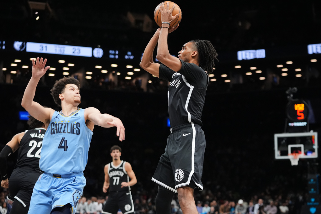 Brooklyn Nets' Ziaire Williams (1) shoots over Memphis Grizzlies' Walter Clayton Jr. (4) during the first half of an NBA basketball game Monday, March 9, 2026, in New York. (AP Photo/Frank Franklin II)